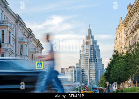 Moscow street scene featuring the modern Oruzheynyy Business Center skyscraper framed by classic historic architecture, Russia Stock Photo