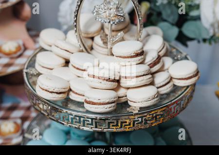 Elegant macarons stack on a decorative glass stand Stock Photo