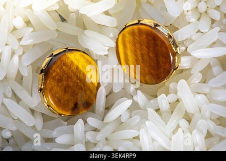 Close-up of vintage tiger eye earrings in gold settings. Stock Photo