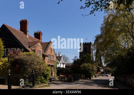 Grappenhall village in the Borough of Warrington in Cheshire. Pictured St Wilfrid's Church and the Rams Head Inn Stock Photo