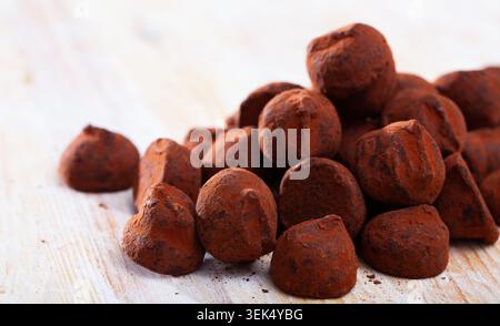 Chocolate truffle candies on wooden table Stock Photo
