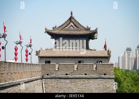 Perspective view of the ancient massive stone wall and watchtower adorned with red lanterns in Xi'an, Shaanxi, China Stock Photo