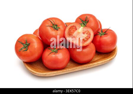 Fresh red tomatoes with a half slice on a wooden tray isolated on white background Stock Photo