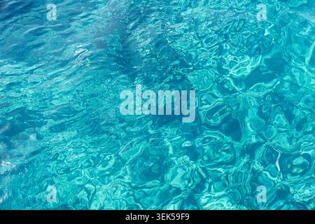 Crystal clear turquoise water surface texture with sunlight patterns over Caribbean sea for a Stock Photo