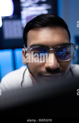 Vertical Portrait Of Indian Software Developer With Code Reflection On Glasses Stock Photo