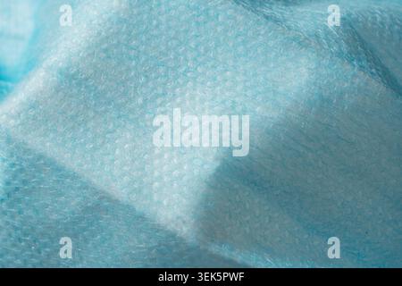 Macro Texture Background of Wrinkled Blue Non Woven Fabric Surgical Face Mask Stock Photo