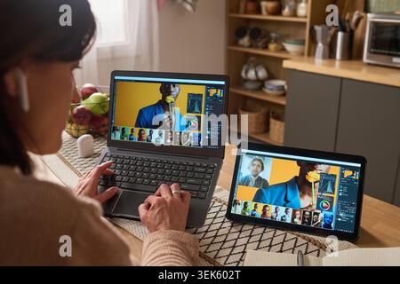 Senior Black Man and Middle Aged Woman Learning Online at Home Stock Photo