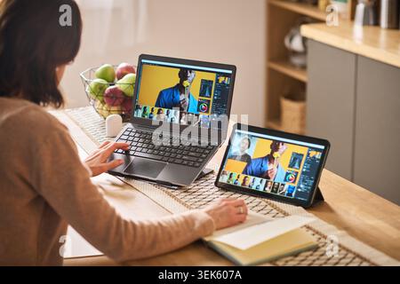 Middle Aged Woman Learning Digital Skills Online at Home Stock Photo