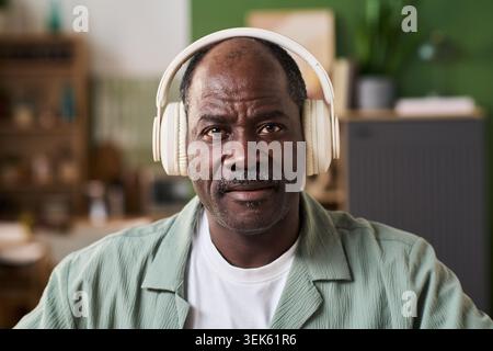 Portrait of Black Senior Man Wearing Headphones for Online Learning Stock Photo