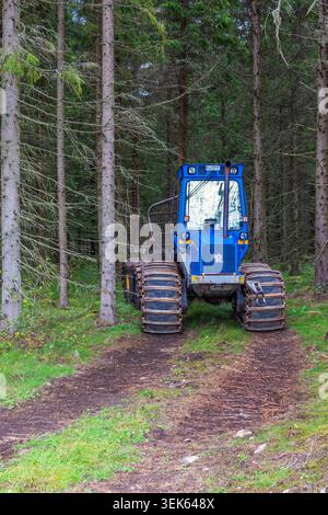 Forwarder on a logging road in a forest Stock Photo