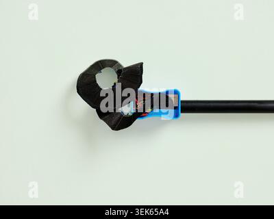 Sharpening black pencil with shavings on green background for creativity concept Stock Photo