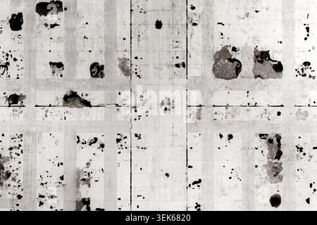 Aerial view of an abstract urban grid pattern with dark spots and textured surfaces in black and white Warsaw, Masovian Voivodeship, Poland. Stock Photo