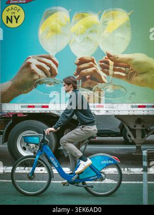 Young man rides a city bike in New York City Stock Photo