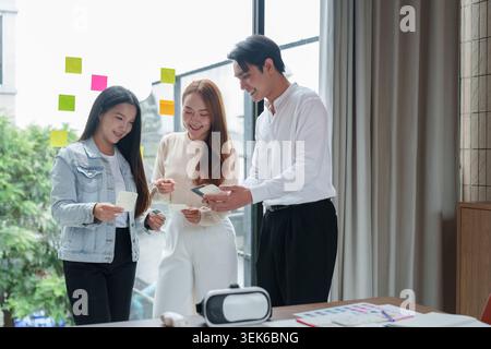 Asian design team discussing project ideas in modern office Stock Photo