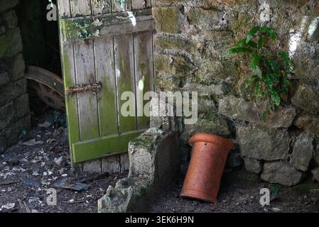 Broken door in an abandoned agricultural building Stock Photo