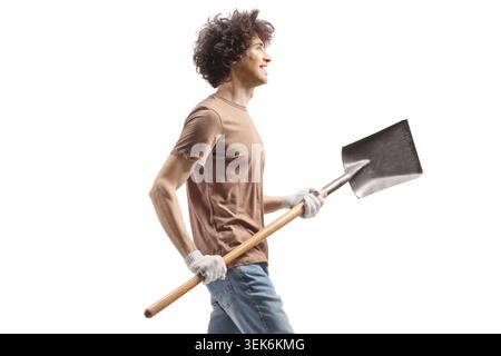 Young man carrying a shovel isolated on white background Stock Photo