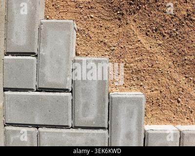 Paving stones being laid on sand for a new patio or walkway Stock Photo