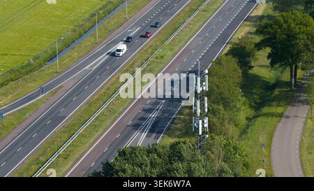 Aerial drone view of a 5G internet antenna and telecom infrastructure along a highway, showcasing wireless connectivity, mobility, transport communica Stock Photo