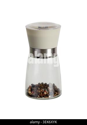 Glass pepper mill grinder filled with mixed peppercorns isolated on a white background Stock Photo