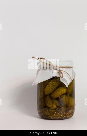 Homemade pickled cucumbers in glass jar on white background Stock Photo