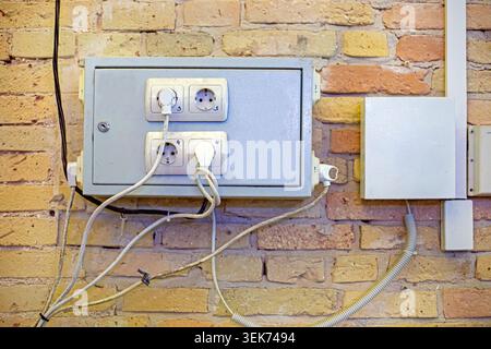Electrical panels on an antique brick wall with numbered outlets Stock Photo