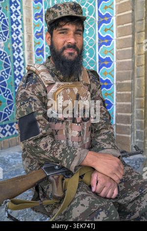 Guard in camouflage uniform carrying a rifle, protecting the shrine Stock Photo