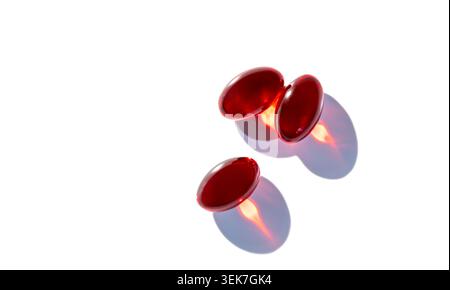 Red Capsules on White Background - Minimalist Health and Wellness Concept Stock Photo