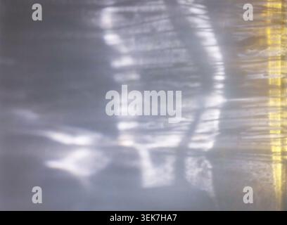 Abstract Light Reflection on Water Surface with Subtle Yellow Hue Stock Photo