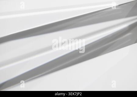 Abstract Light and Shadow on Geometric Metallic Surface in Minimalist Design Stock Photo