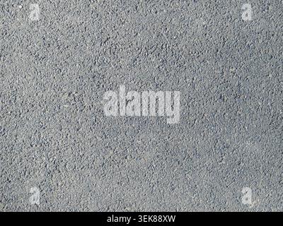 Empty background of gray cement plaster on the wall, textured relief of the wall plastered with concrete mixture, monochrome rough background Stock Photo