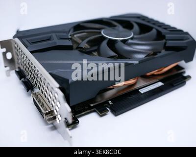 Modern graphics card with fan cooler on white background. Computer hardware, gaming GPU rendering unit, electronic component. Stock Photo