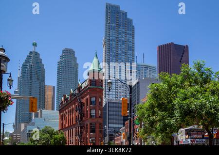 Historic Gooderham Building, also known as the Flatiron Building with modern skyscrapers with background in Toronto Stock Photo