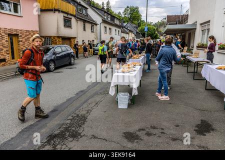 Refreshment station in the centre of town during the 14th Frankenwald Walking Marathon: tables laden with bread rolls and pastries for participants in Ludwigsstadt, Bavaria, Germany Stock Photo