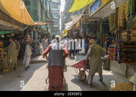 Shoppers and vendors engaging in commerce and daily life activities in a bustling bazaar Stock Photo
