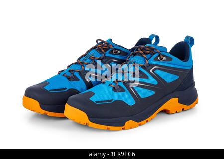 Blue And Orange Trail Hiking Shoes or trekking boots With Rugged Rubber Soles And Laces For Outdoor Adventure isolated on white background Stock Photo