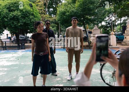 Young people posing for smartphone picture, creating content outdoors Stock Photo