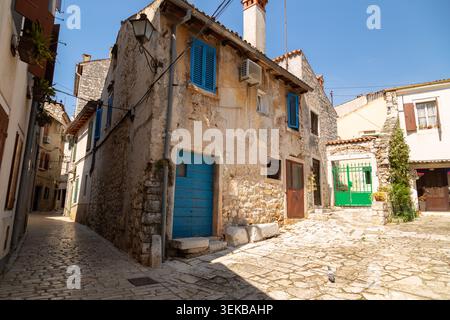 Old rustic stone buildings with colorful doors and shutters in Rovinj Old Town, Istria, Croatia. Stock Photo
