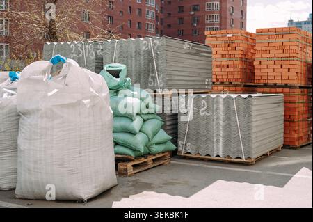 Construction materials for residential roof renovation stored at building site Stock Photo