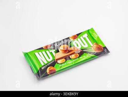 Kyiv, Ukraine - May 17, 2024: Packages of Roshen milk chocolate bar with whole hazelnuts Nut Out, product shot closeup on white background. Stock Photo