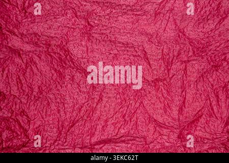 Red bubble wrap texture surface with glossy circular raised pattern Stock Photo