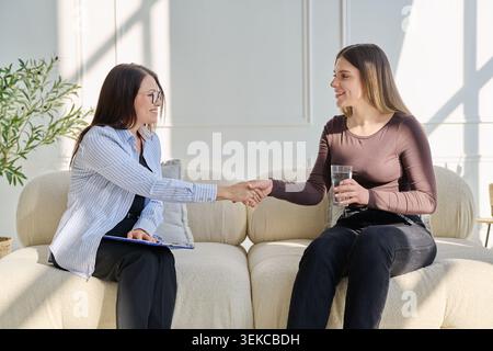 Young woman in therapy session talking with psychotherapist Stock Photo
