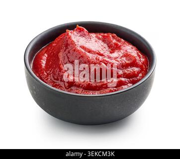 studio shot of rich red tomato sauce, paste, or ketchup served in a minimalist black ceramic bowl. Cleanly isolated on a pure white background with a Stock Photo