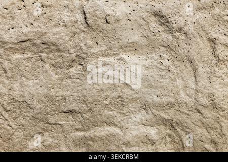 Beige stone texture. Rough concrete wall surface background. Stock Photo