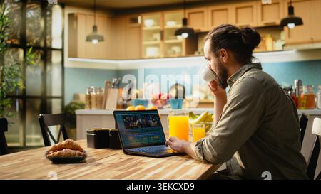 Videographer editing video footage on laptop using professional software, timeline editing to create montage and color grading. Remote work with digital tools, productivity and video production. Stock Photo