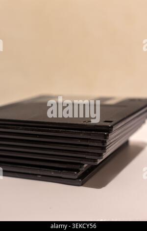 A stack of old floppy disks for PCs. Old plastic disks for computers. Data and file save. Stock Photo
