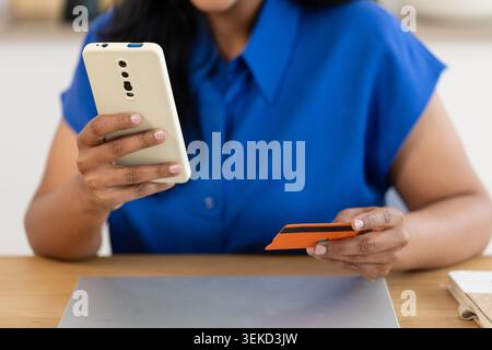 Close up of Indian woman paying online with credit card Stock Photo