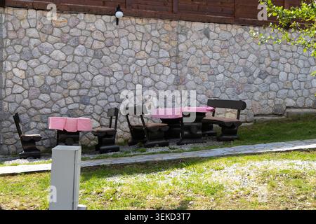 Serbia El Paso City 25.05.2026 Outdoor Rustic Wooden Benches Beside Stone Wall Stock Photo