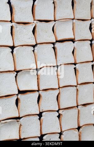 uncooked slices of bread in a row creating a checkered pattern Stock Photo
