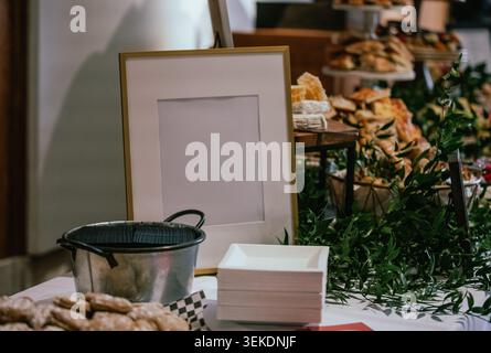 view of a white blank menu frame on a buffet table during an event indoor Stock Photo