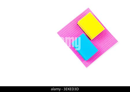 Colorful cleaning sponges and microfiber cloth isolated on white background. Household cleaning supplies arranged in minimal composition with copy spa Stock Photo